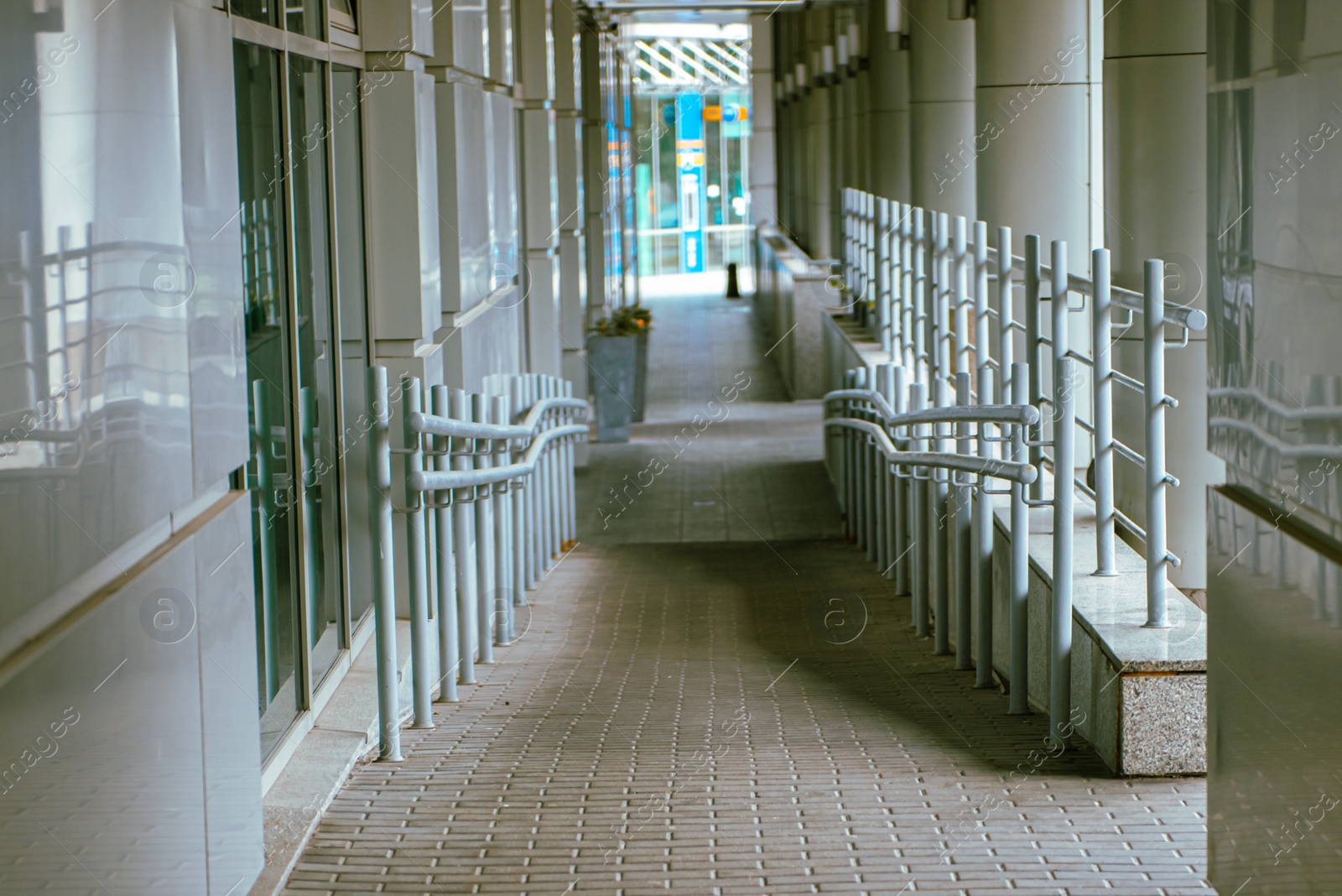 Photo of Brick ramp with shiny metal railings inside