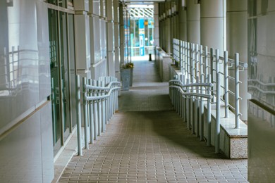 Brick ramp with shiny metal railings inside