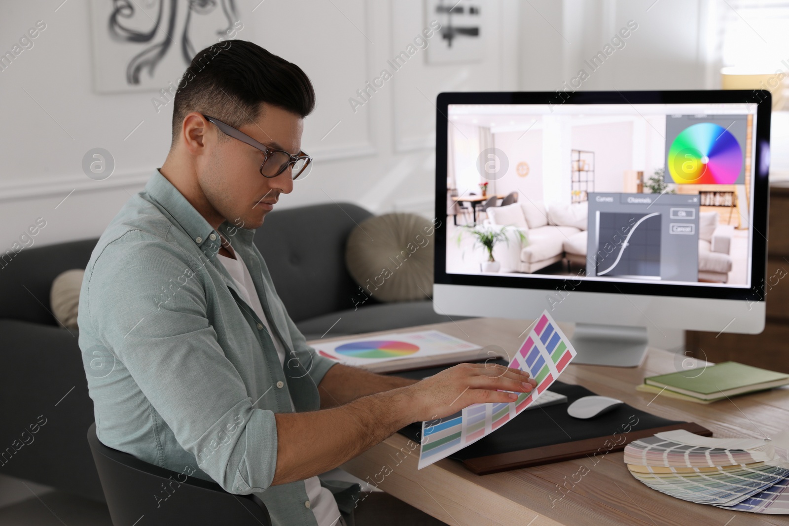 Photo of Professional retoucher working on computer in office