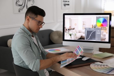 Professional retoucher working on computer in office