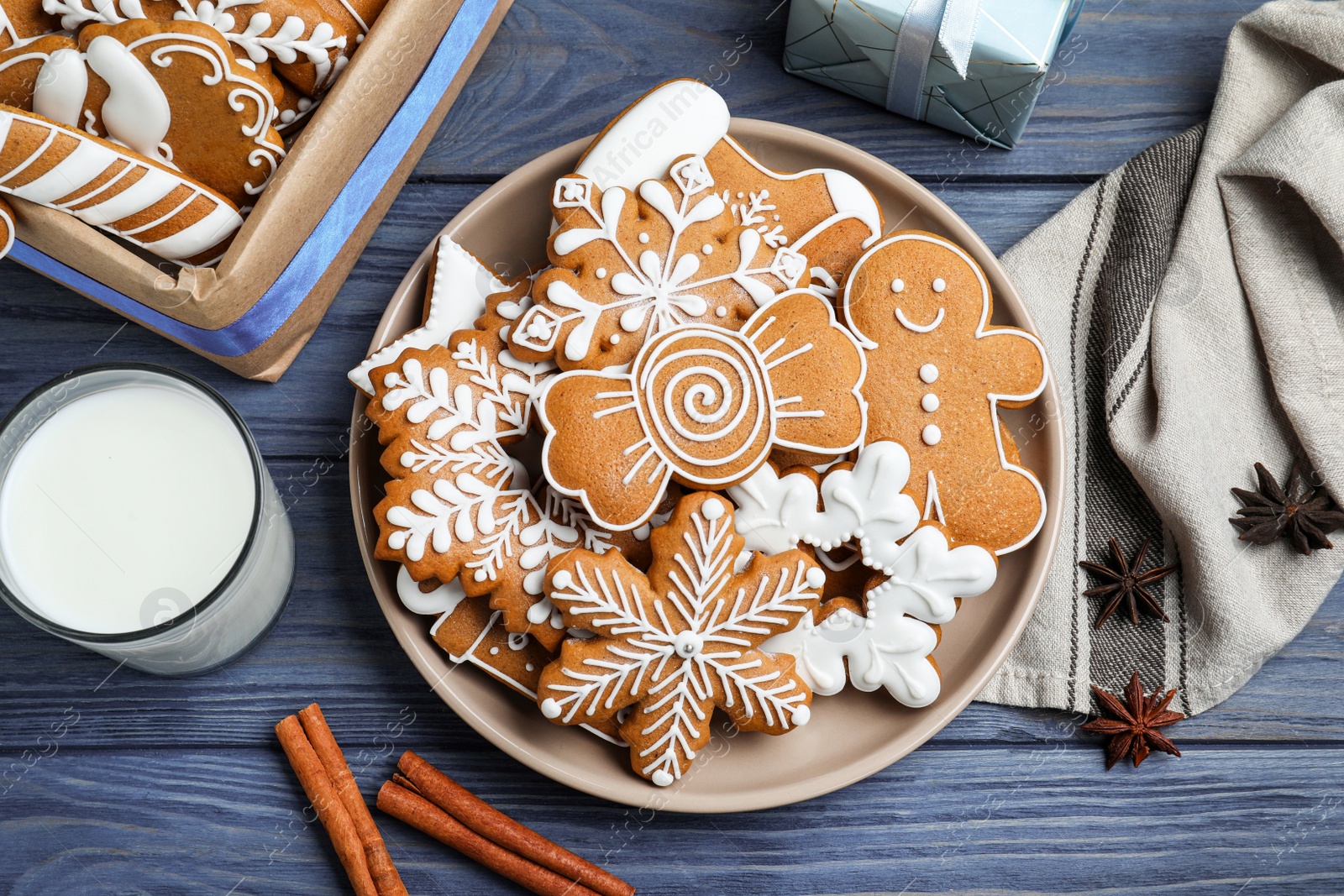 Photo of Delicious Christmas cookies on blue wooden table, flat lay