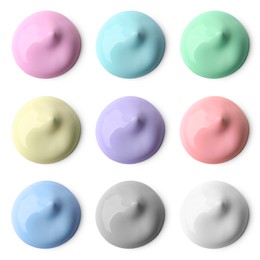 Paint blobs of different colors on white background, top view