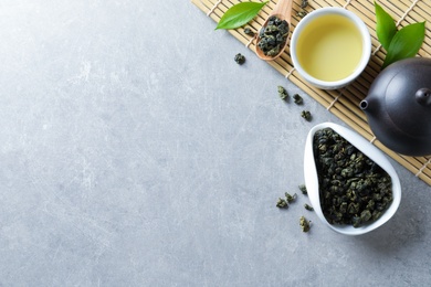 Flat lay composition with cup of Tie Guan Yin oolong tea and space for text on grey background