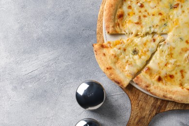 Photo of Delicious cheese pizza on light grey table, flat lay. Space for text