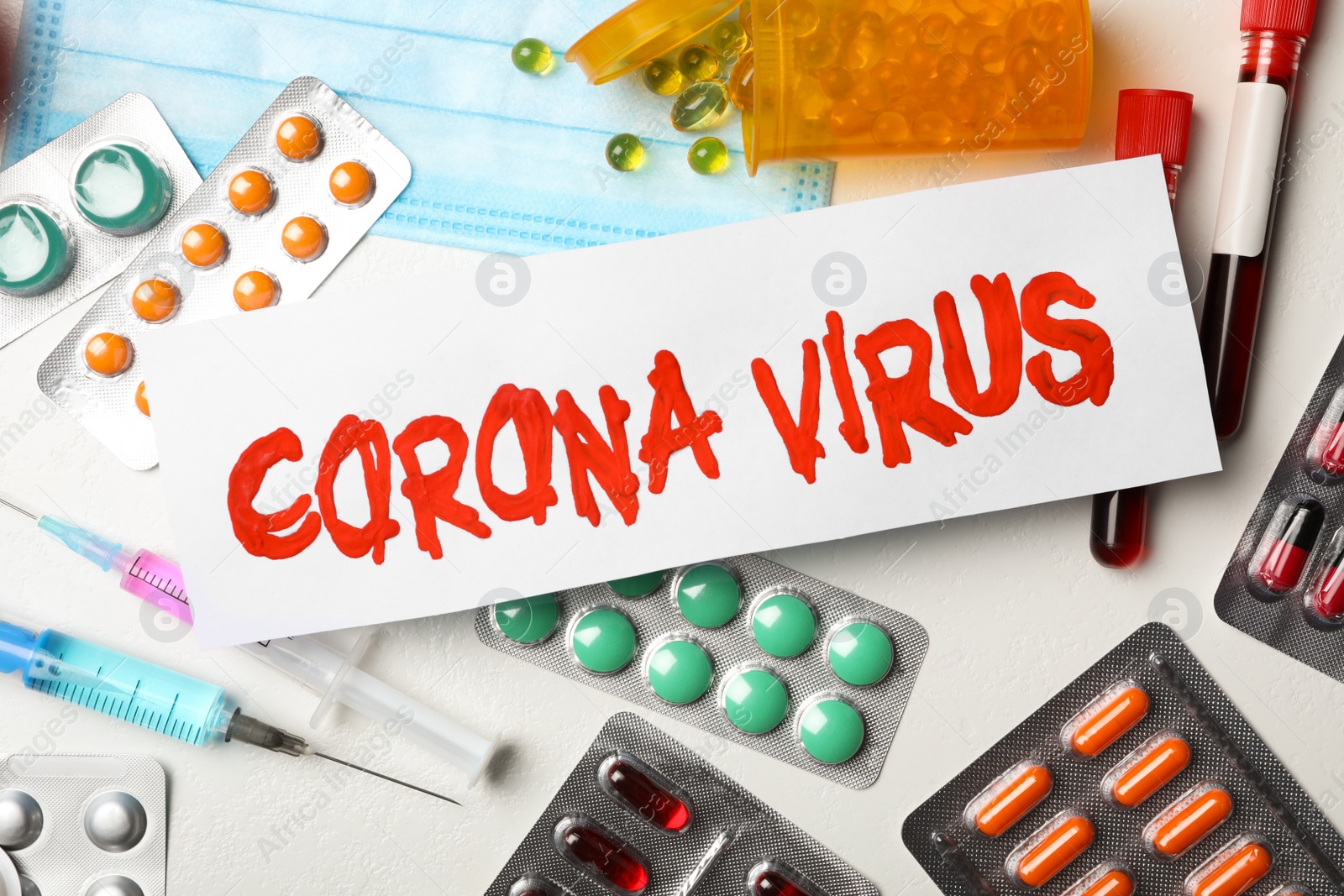 Photo of Flat lay composition with phrase CORONA VIRUS and medicines on white background