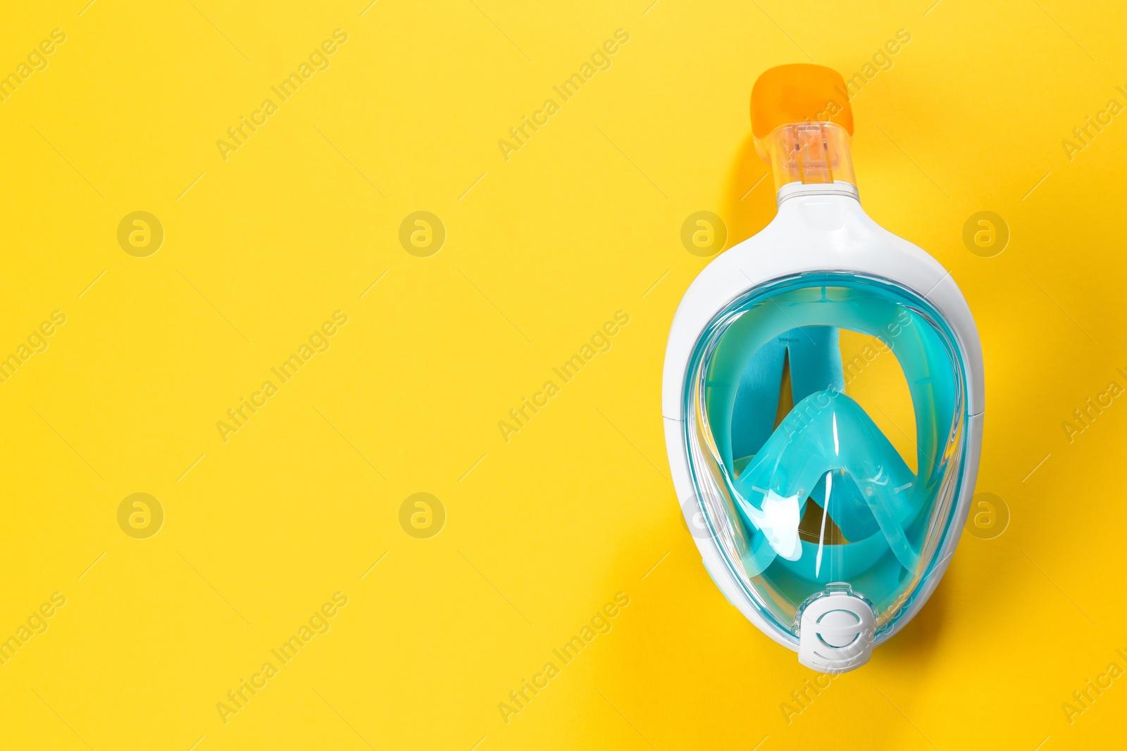 Photo of Diving mask on color background, top view. Space for text