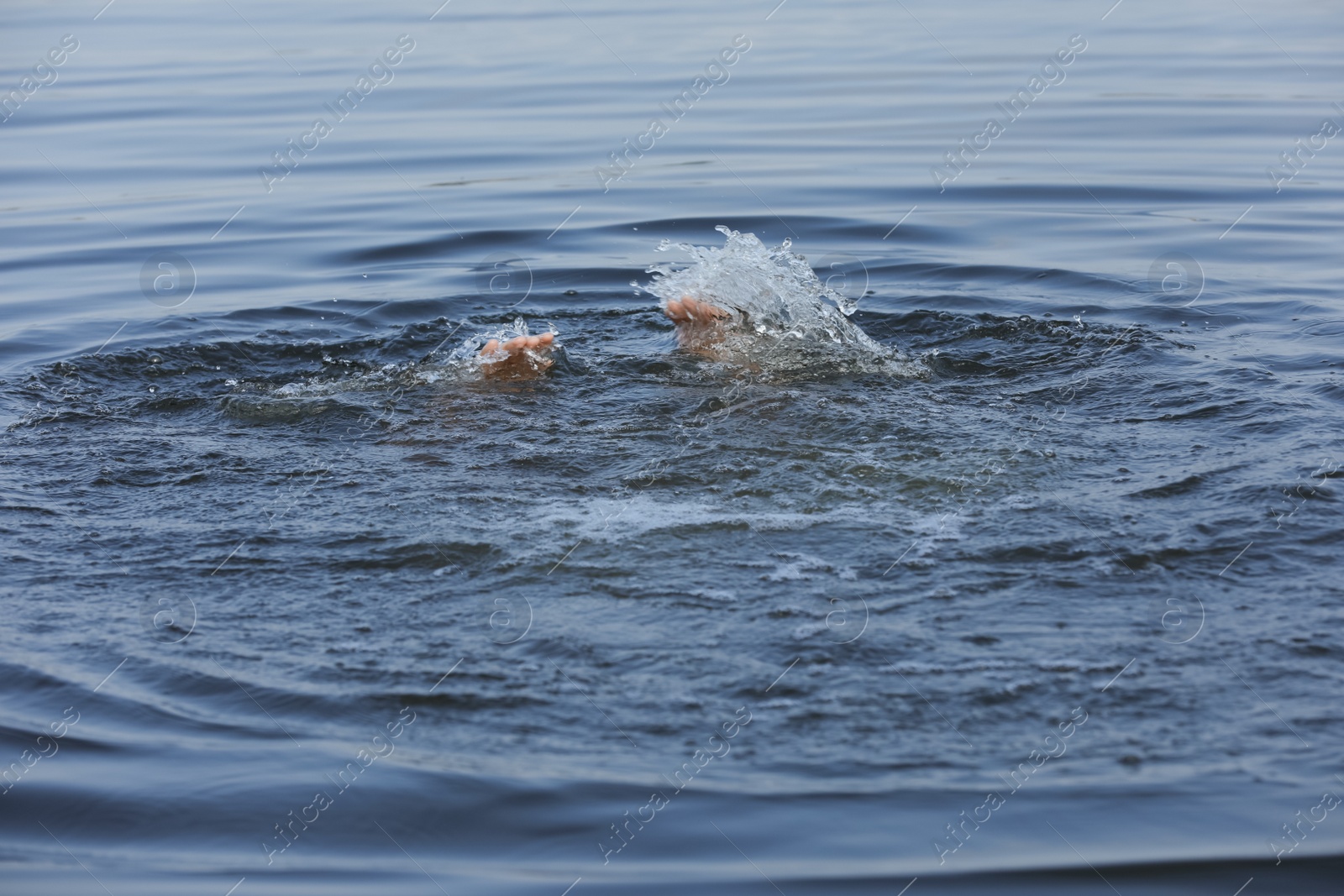 Photo of Drowning man reaching for help in sea, closeup