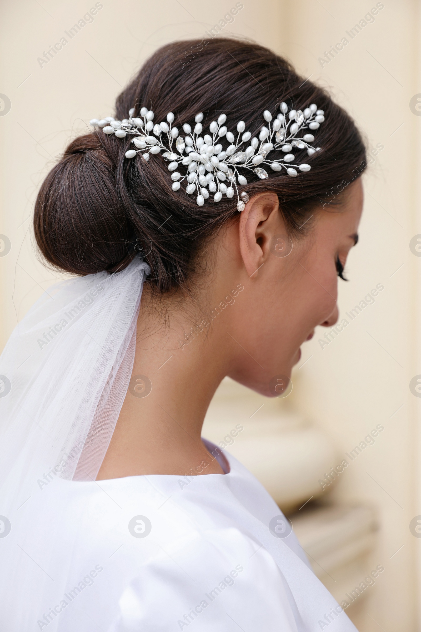 Photo of Young bride with elegant wedding hairstyle outdoors