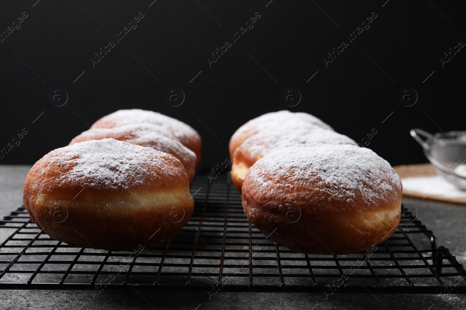 Photo of Delicious sweet buns on table against black background, closeup. Space for text