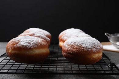 Delicious sweet buns on table against black background, closeup. Space for text