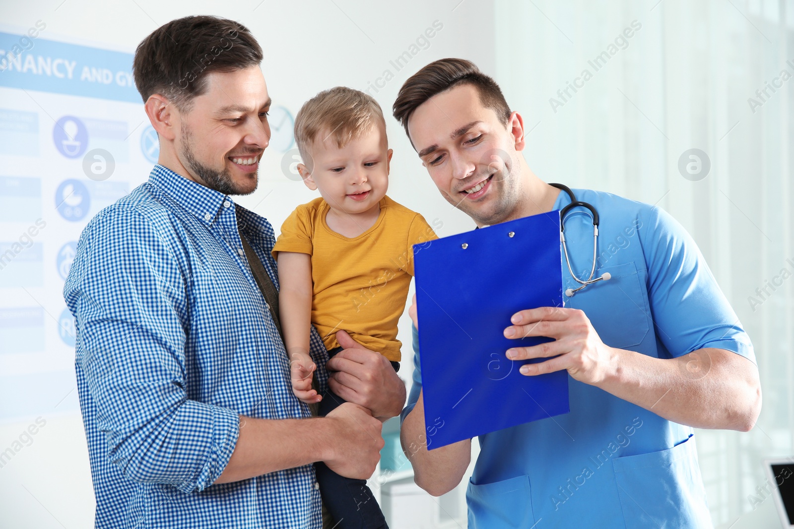 Photo of Father with child visiting doctor in hospital