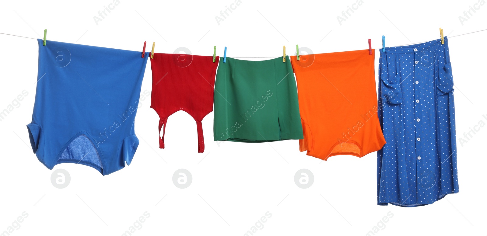 Photo of Different clothes drying on laundry line against white background