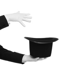 Photo of Magician showing magic trick with top hat on white background, closeup