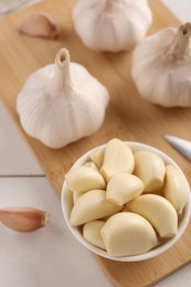 Fresh garlic on white wooden table, closeup. Above view