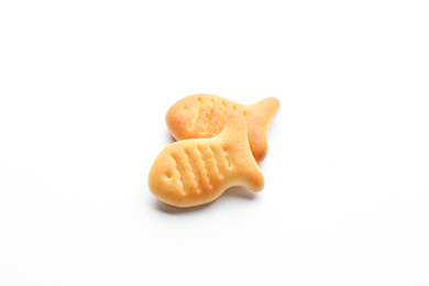 Delicious crispy goldfish crackers on white background