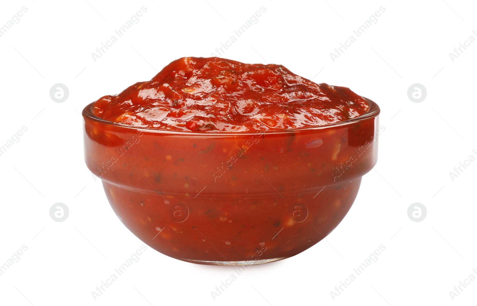 Photo of Delicious adjika sauce in glass bowl isolated on white