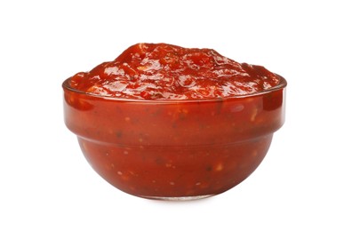 Photo of Delicious adjika sauce in glass bowl isolated on white