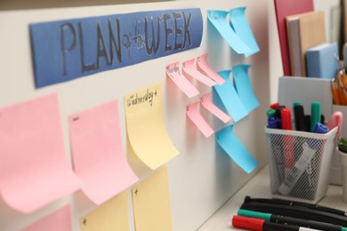 Photo of Business process planning and optimization. Workplace with colorful paper notes and other stationery on table, closeup