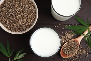 Flat lay composition with fresh hemp milk on wooden table