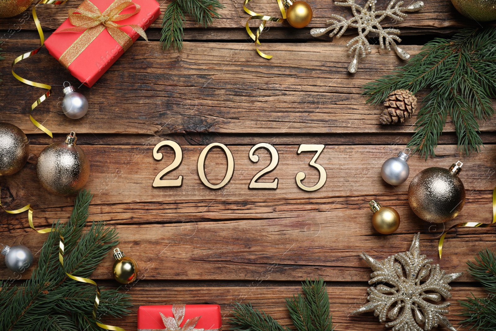 Photo of Flat lay composition with number 2023 and festive decor on wooden background. Happy New Year