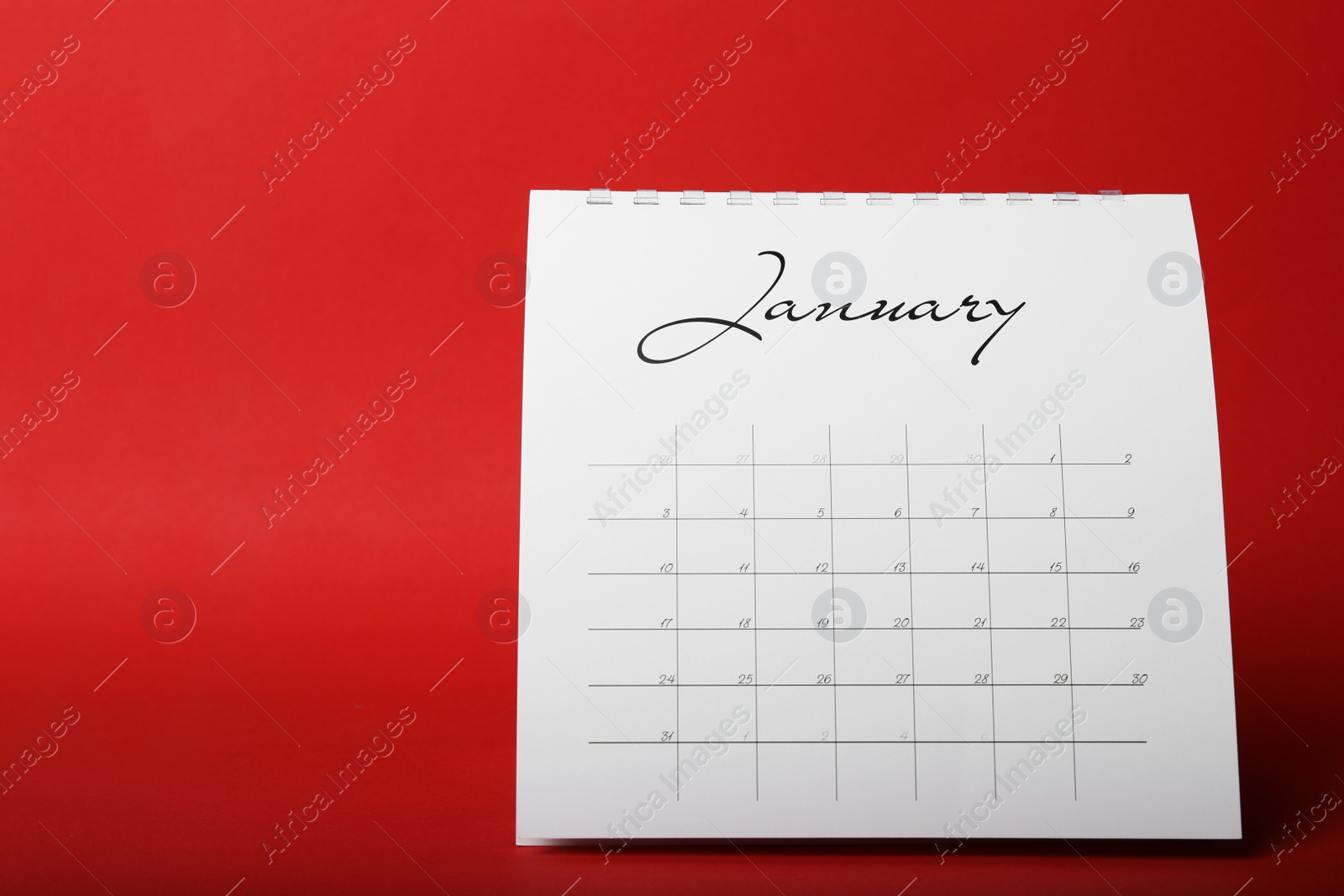 Photo of Paper calendar on red background. Planning concept