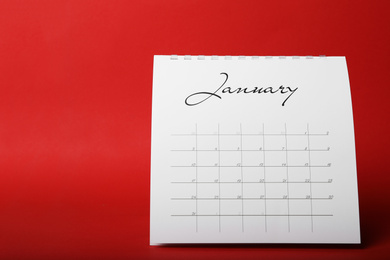 Photo of Paper calendar on red background. Planning concept