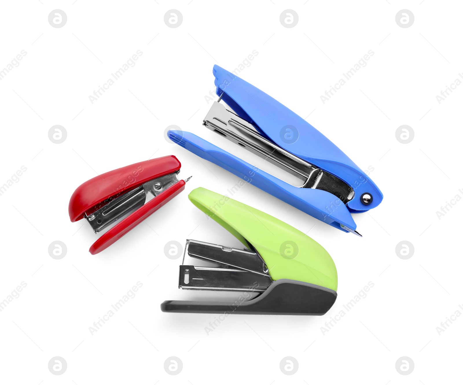 Photo of Bright color staplers isolated on white, top view