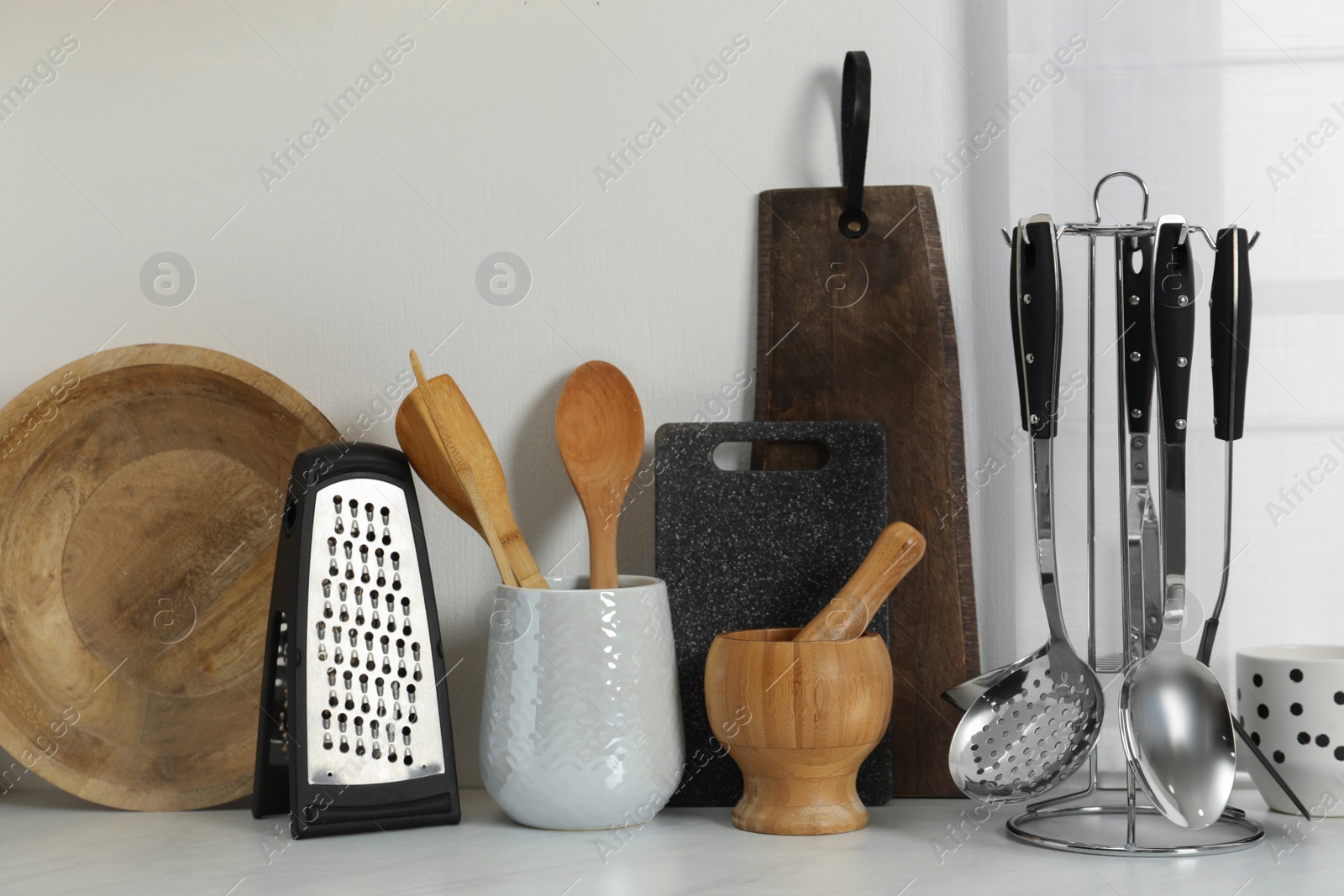 Photo of Different cooking utensils on countertop in kitchen