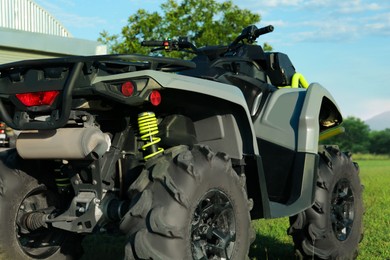 Photo of Modern quad bike in field on sunny day, closeup