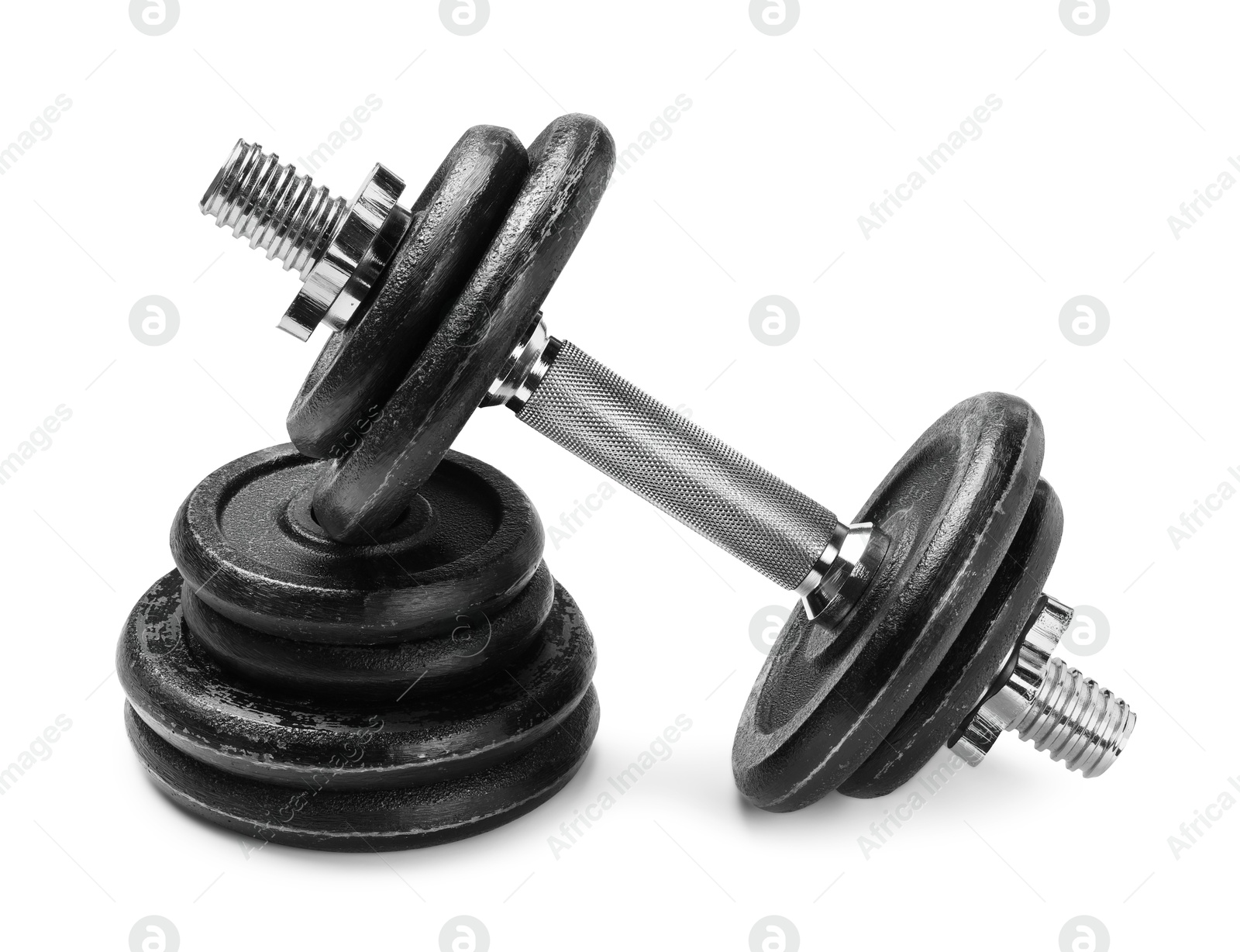 Photo of Metal dumbbells and weight plates on white background. Sports equipment