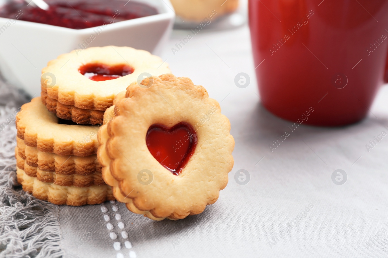 Photo of Traditional Christmas Linzer cookies with sweet jam on table