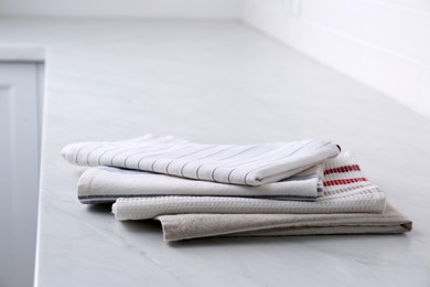 Stack of soft kitchen towels on countertop indoors