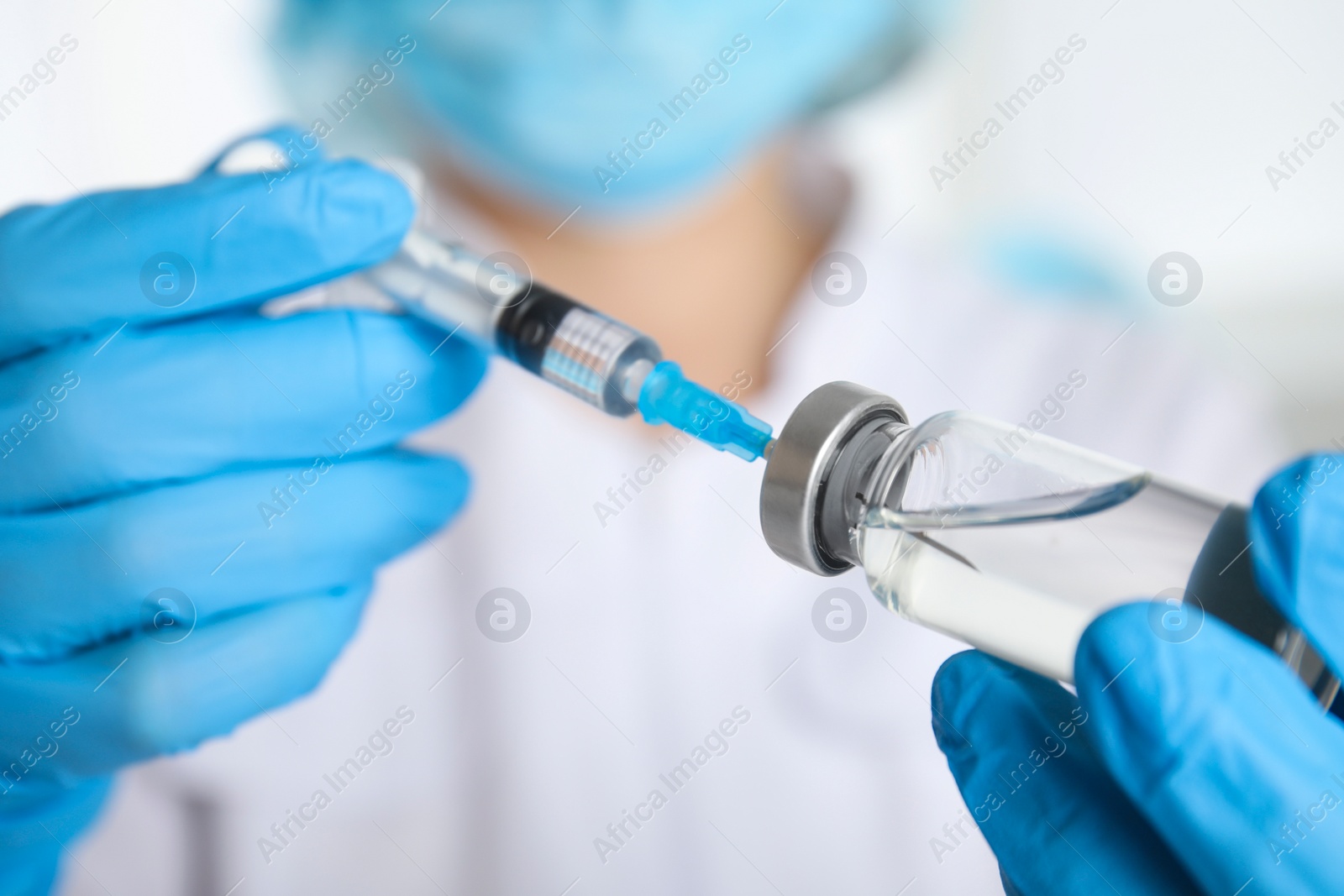 Photo of Doctor filling syringe with medication, closeup. Vaccination and immunization