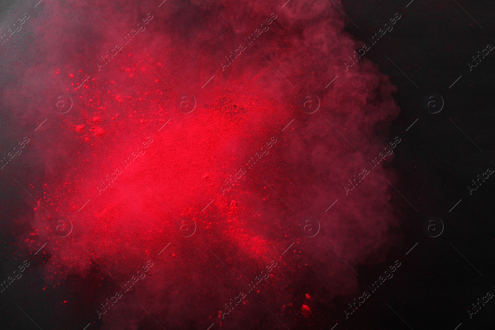 Photo of Red powder dye on dark background, top view. Holi festival