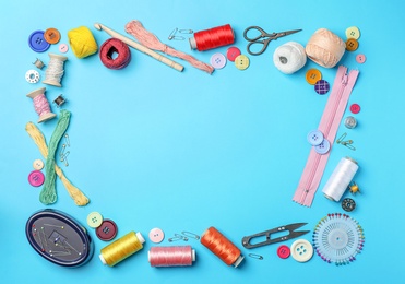 Composition with threads and sewing accessories on color background, flat lay