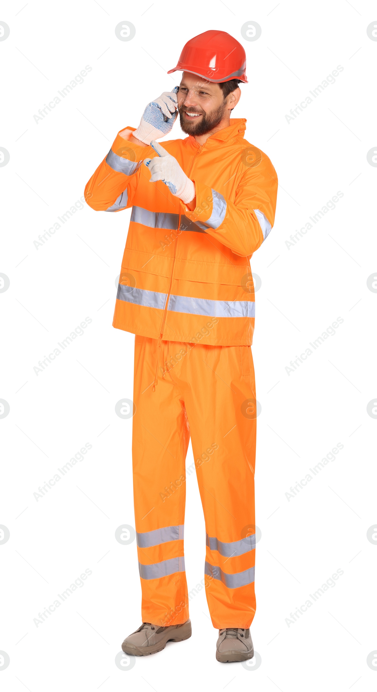 Photo of Man in reflective uniform talking on smartphone against white background