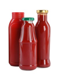 Photo of Different bottles of ketchup on white background