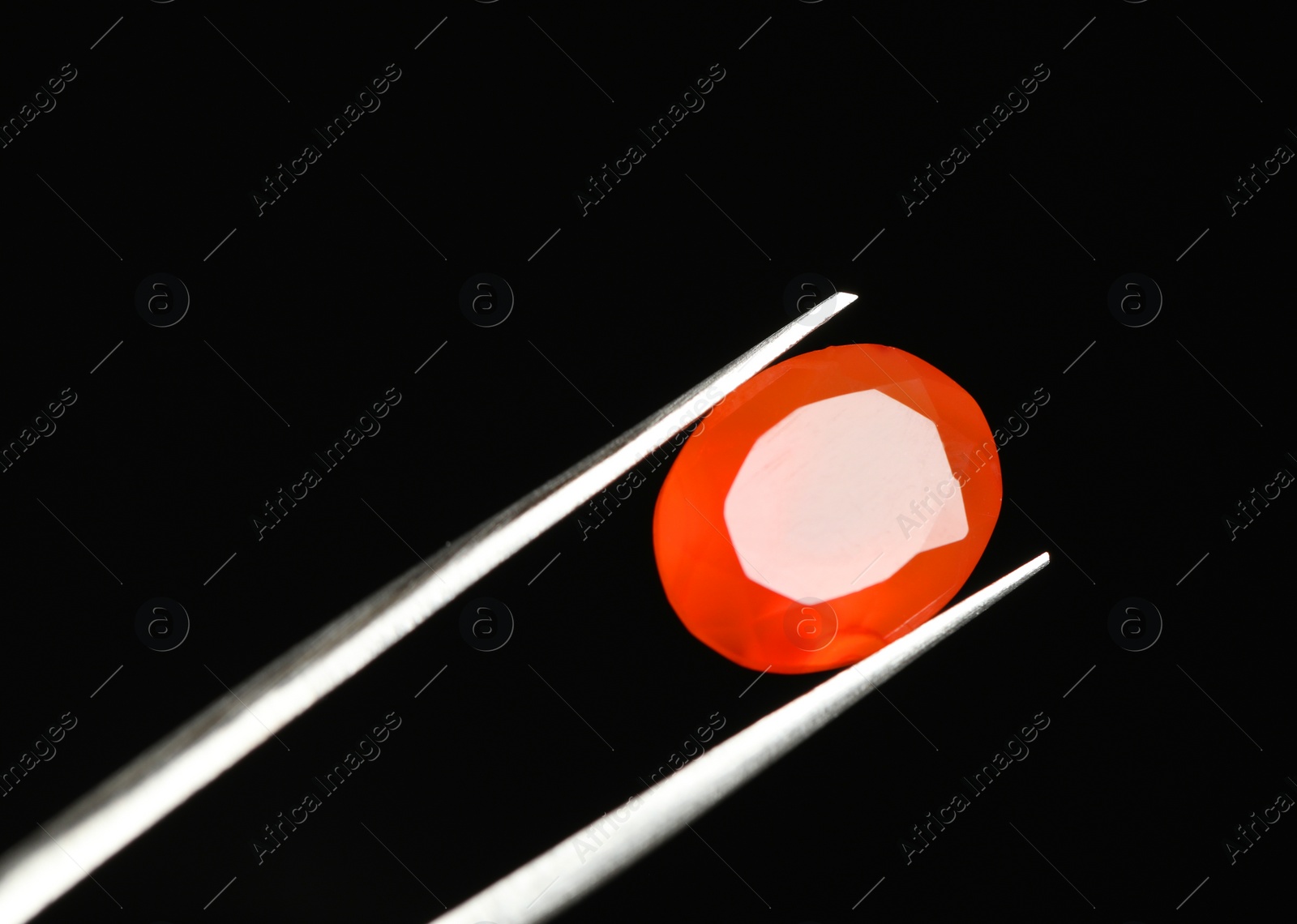 Photo of Tweezers with beautiful gemstone on black background. Space for text