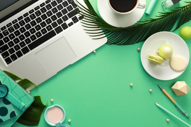 Flat lay composition with laptop on green background. Fashion blogger