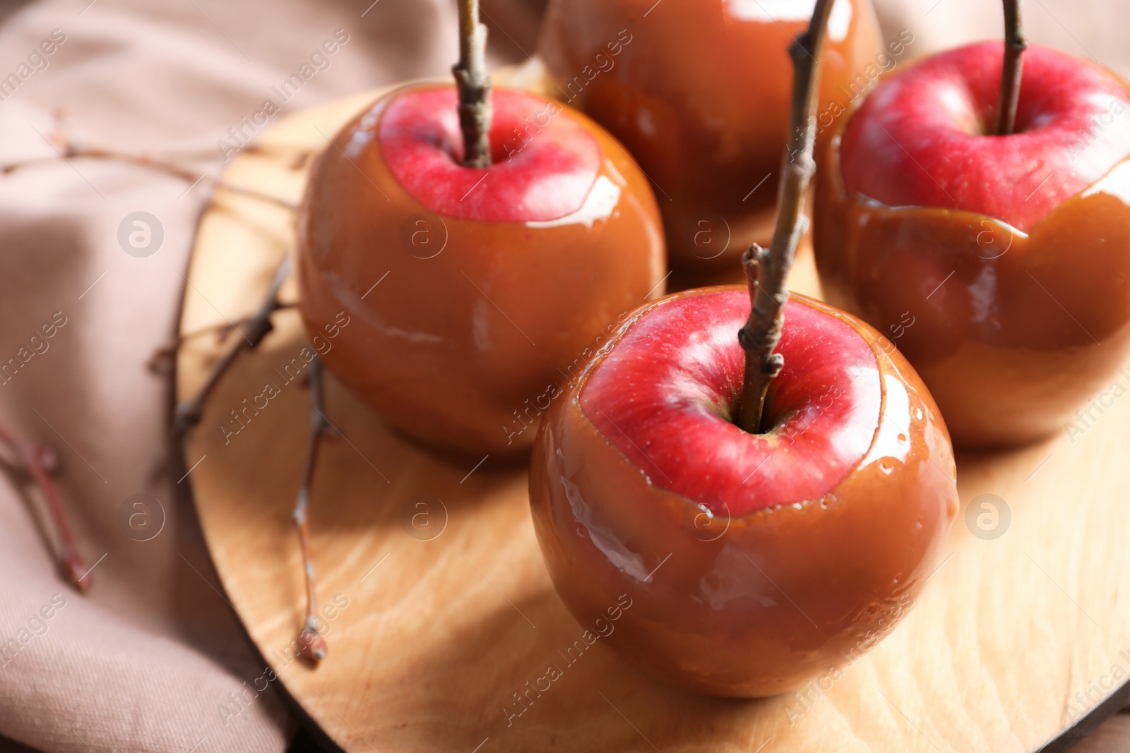 Photo of Plate with delicious caramel apples, closeup