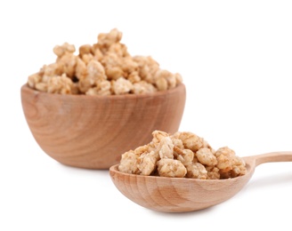 Image of Tasty crispy granola in wooden bowl and spoon on white background