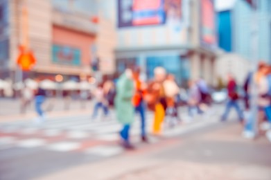 Photo of People crossing street in city, blurred view