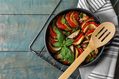 Delicious ratatouille on light blue wooden table, top view. Space for text