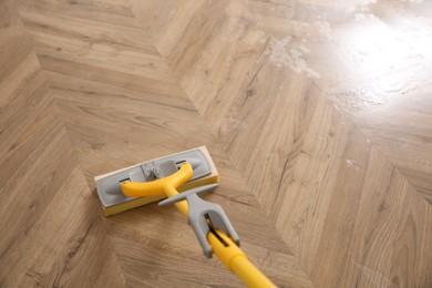 Washing of parquet floor with mop, above view. Space for text
