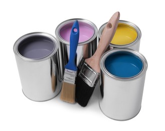 Cans of different paints and brushes on white background