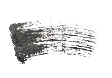 Photo of Smear of black mascara for eyelashes on white background