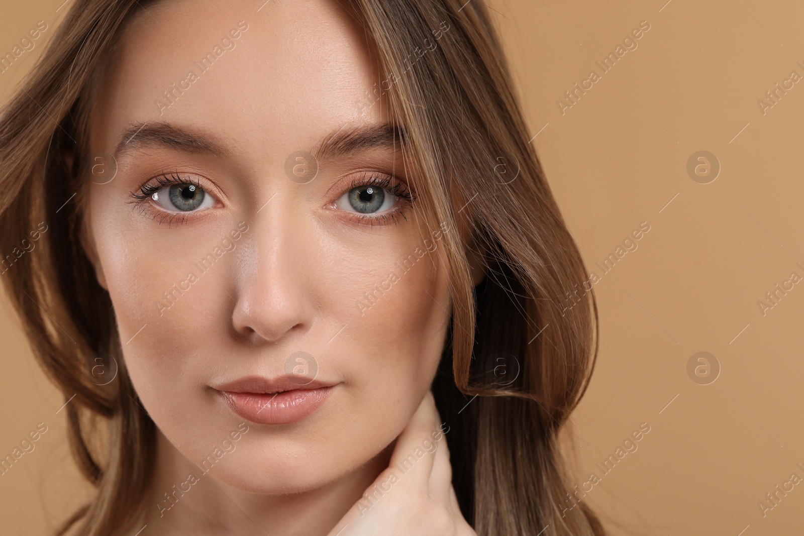 Photo of Beautiful woman with healthy skin on beige background, closeup