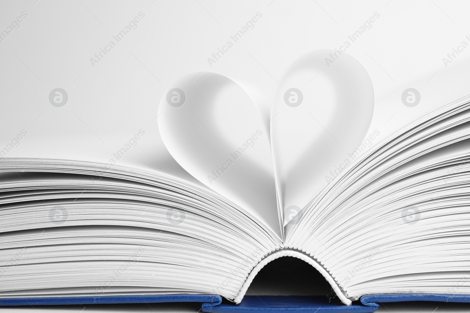 Photo of Closeup view of open book on white background
