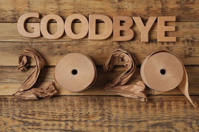 Flat lay composition with text Goodbye 2020 on wooden background, flat lay