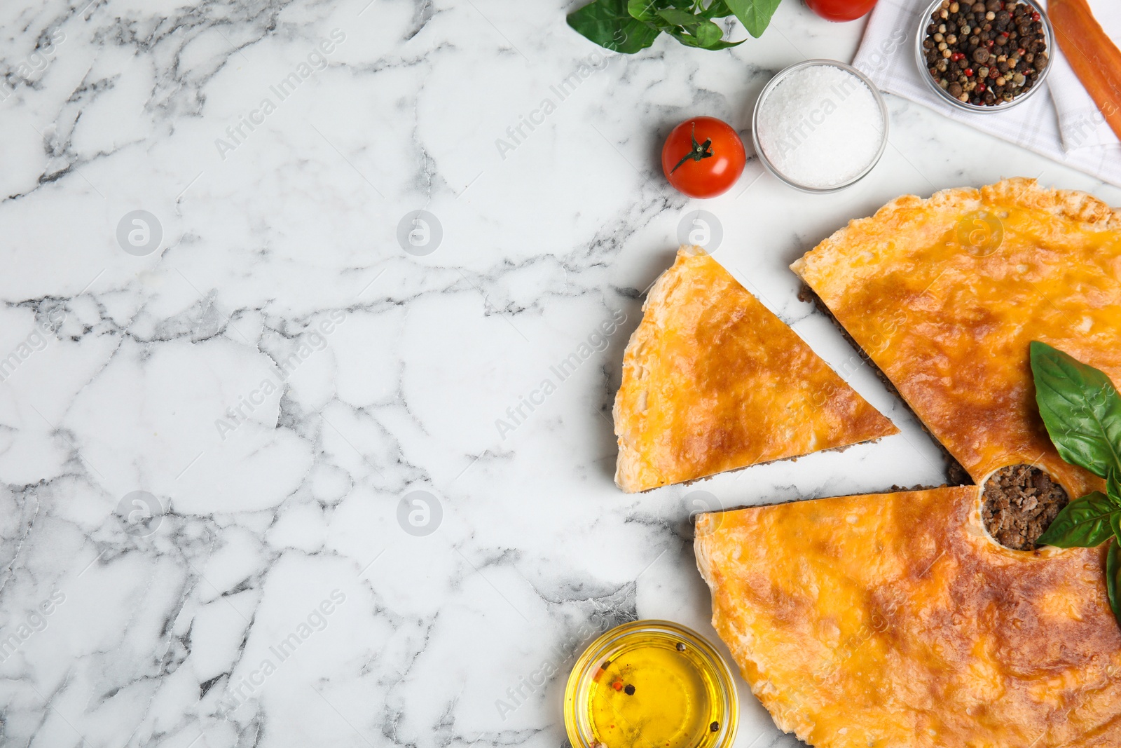 Photo of Delicious pie with minced meat and ingredients on white marble table, flat lay. Space for text